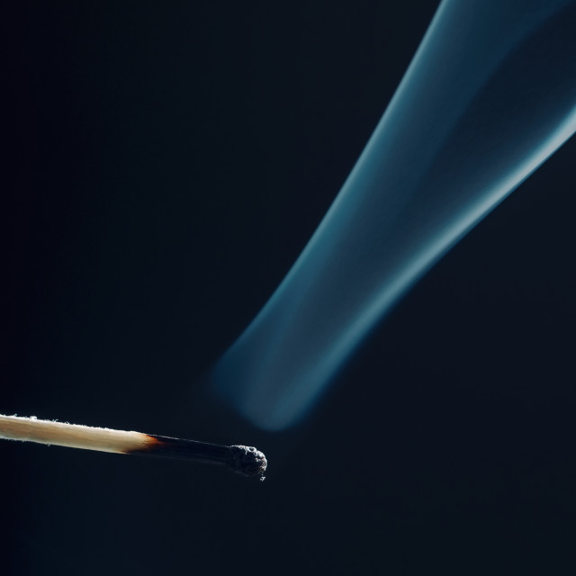 "Match stick with burnt head and smoke around" stock image