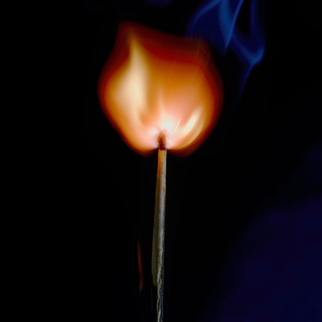 "Safety match on black background with flaming head" stock image