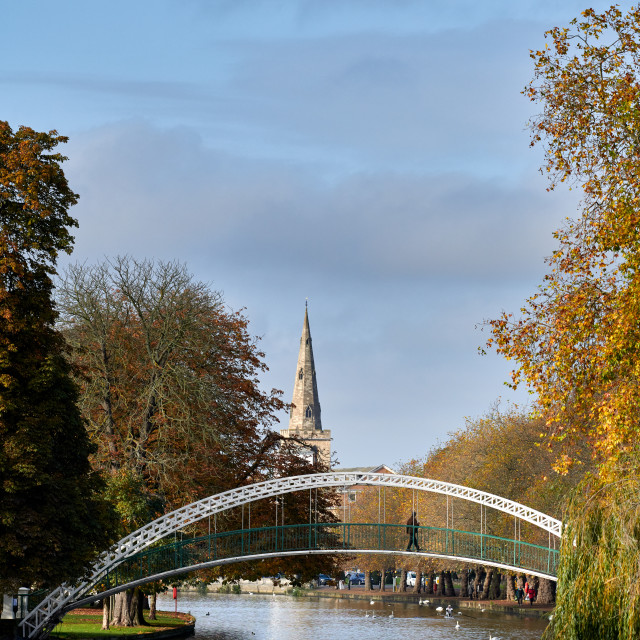 "A rower passes under Bedford Suspension Bridge on an autumn morn" stock image