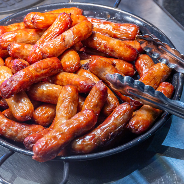 "Pile of cooked sausages in a skillet pan" stock image