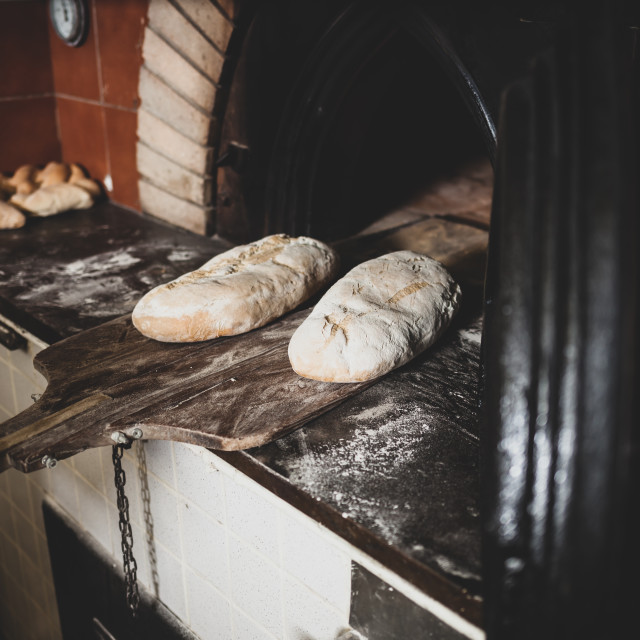 "Production of baked bread with a wood oven in a bakery." stock image