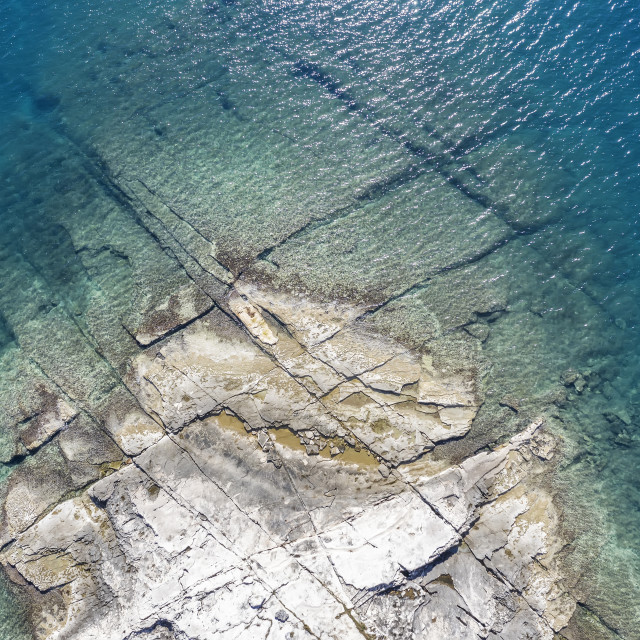 "An aerial view of the beach with flat rocky cliffs" stock image