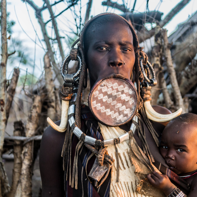 "Mursi woman with his kid" by Anibal Bueno - $12.20 "Mursi woman with his kid" stock image