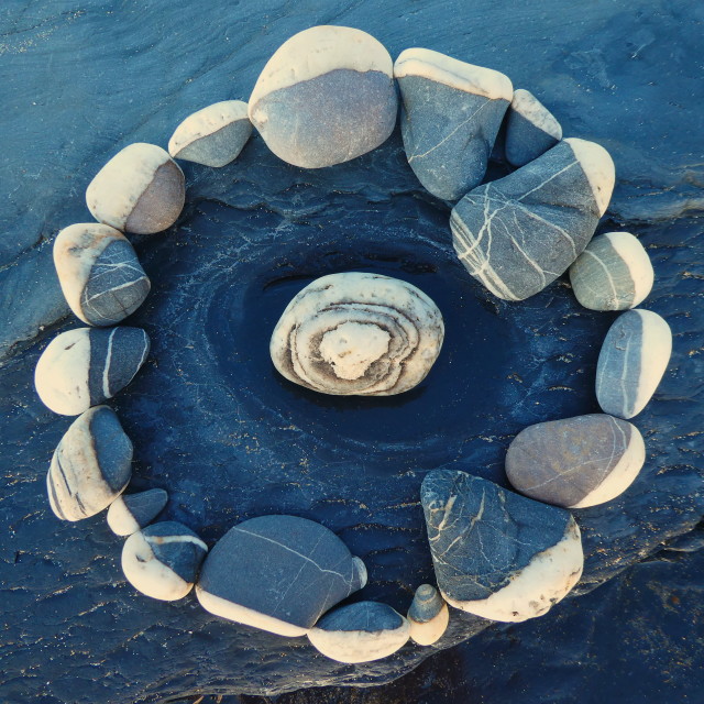 "pebble circle on a beach rock" stock image