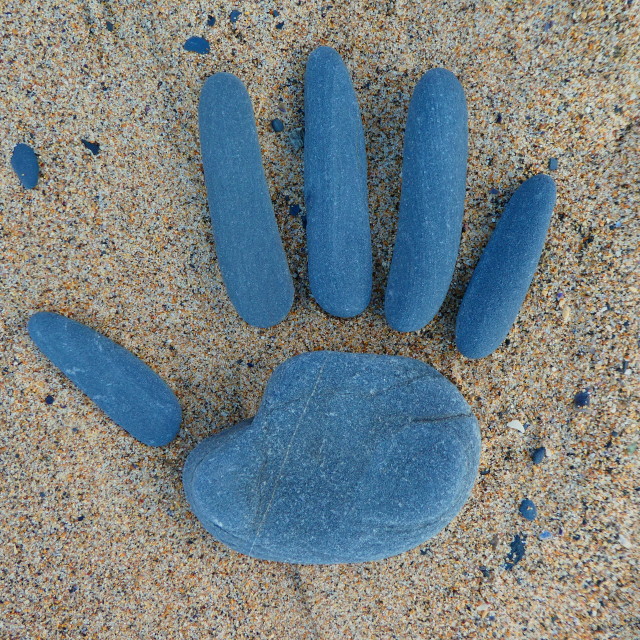 "hand from beach pebbles" stock image