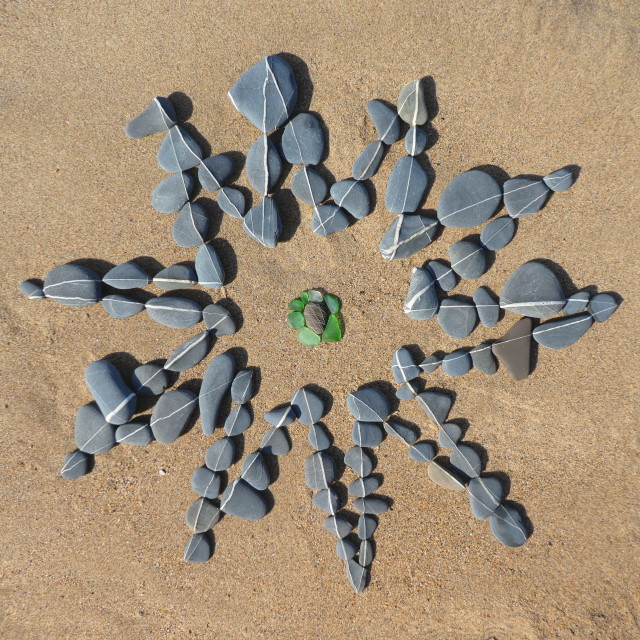 "a star made from beach pebbles" stock image