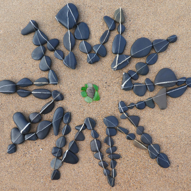 "a star made from beach pebbles" stock image