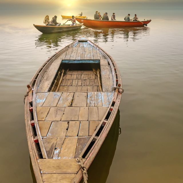 "Hand-rowing wooden boats is been used to take tourist and products around not the river Ganges in India" stock image