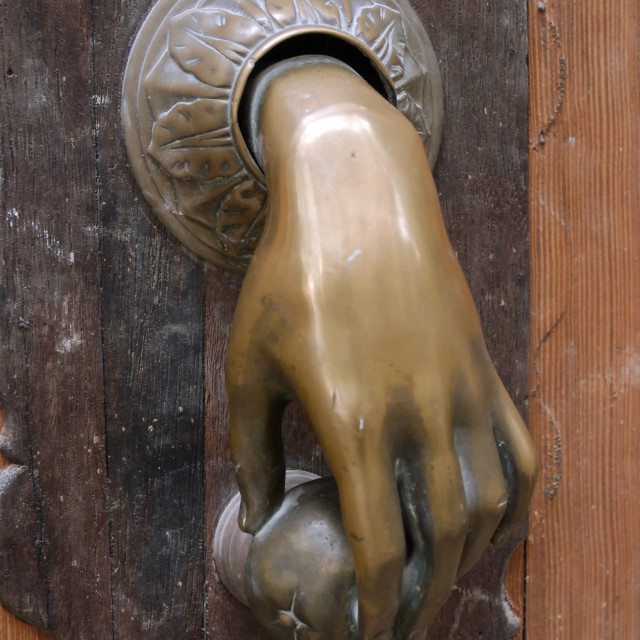 "Metal hand, very old Door knocker. Türklopfer an alter spanischer Tür." stock image