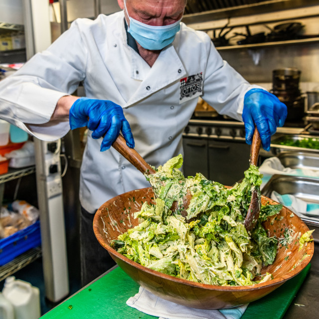"Chef wearing PPE supporting frontline workers by making meals each day" stock image