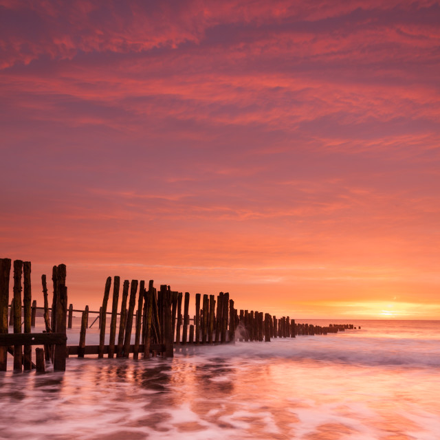 "Sunrise at Old Groyne Dawlish Warren" by Bruce Little - £20.00 "Sunrise at Old Groyne Dawlish Warren" stock image