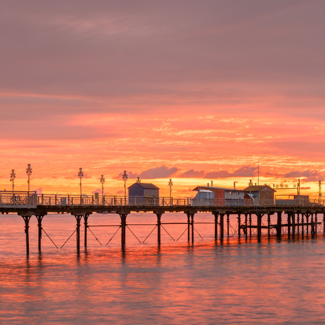 "Sunrise at Teignmouth Pier" by Bruce Little - £20.00 "Sunrise at Teignmouth Pier" stock image