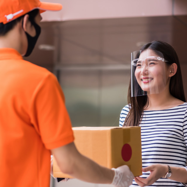 "deliveryman deliver to smiling office woman" stock image