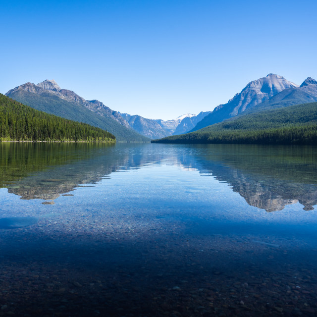"Calm Lake Bowman with a Reflection of Mountains in the Backgroun" by Justin Mueller - £10.00 "Calm Lake Bowman with a Reflection of Mountains in the Backgroun" stock image