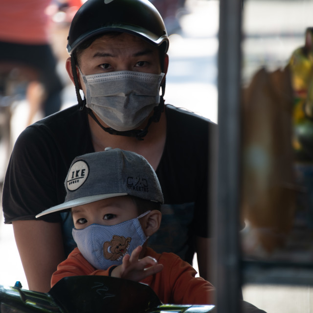 "People in Vietnam wearing facemasks against the air pollution and covid19" by frederik enneman - £20.00 "People in Vietnam wearing facemasks against the air pollution and covid19" stock image