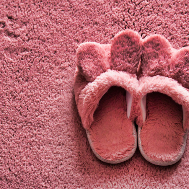 "Pink slippers over pink carpet" stock image