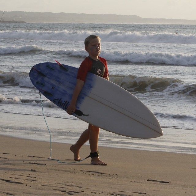 "Surfer Kid Walks Down on Kuta Beach" stock image