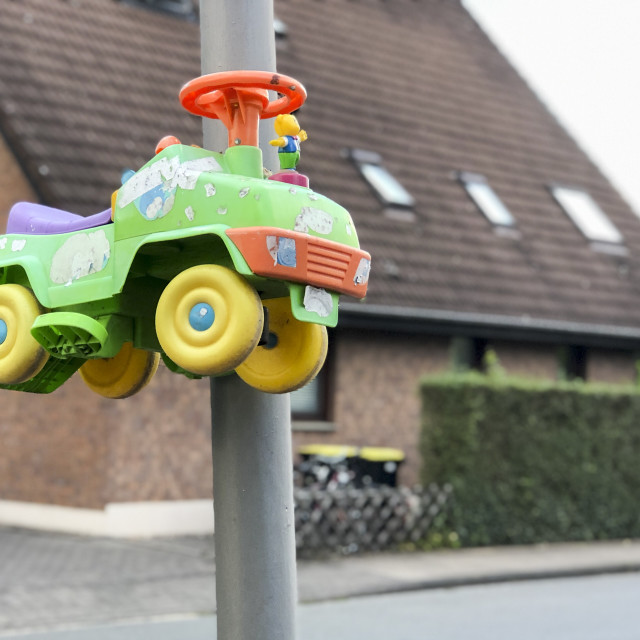 "Bobbycar attached to a street lamp" stock image