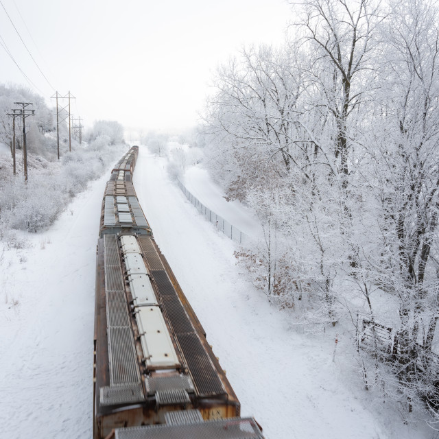 "train passing through fresh snow fall on the tracks" by Justin Mueller - £10.00 "train passing through fresh snow fall on the tracks" stock image