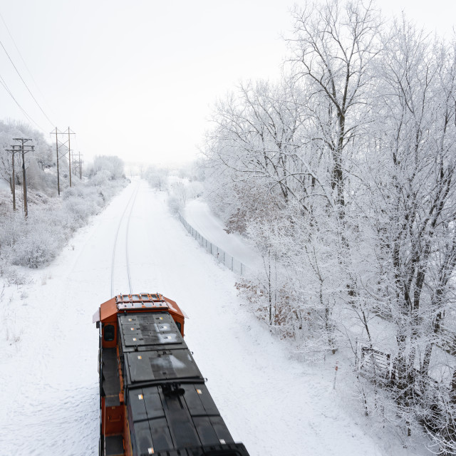 "train passing through fresh snow fall on the tracks" by Justin Mueller - £10.00 "train passing through fresh snow fall on the tracks" stock image