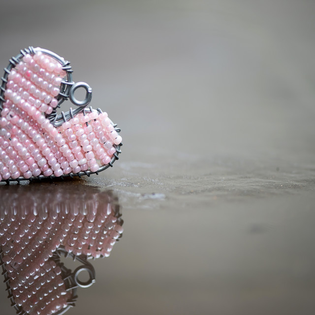 "Pink wire and bead heart with relection" stock image