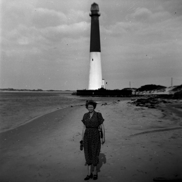 "Woman posing in front of an old light house" by Zachary I Peabody - £10.00 "Woman posing in front of an old light house" stock image