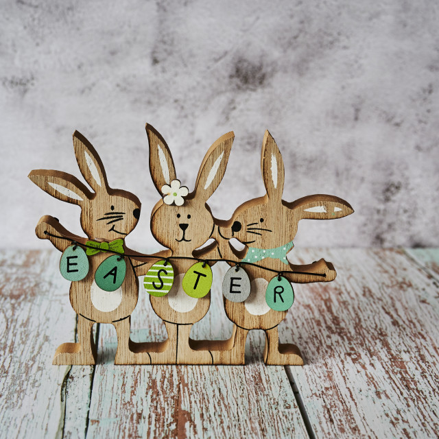 "Three wooden Easter bunnies with decoration." stock image