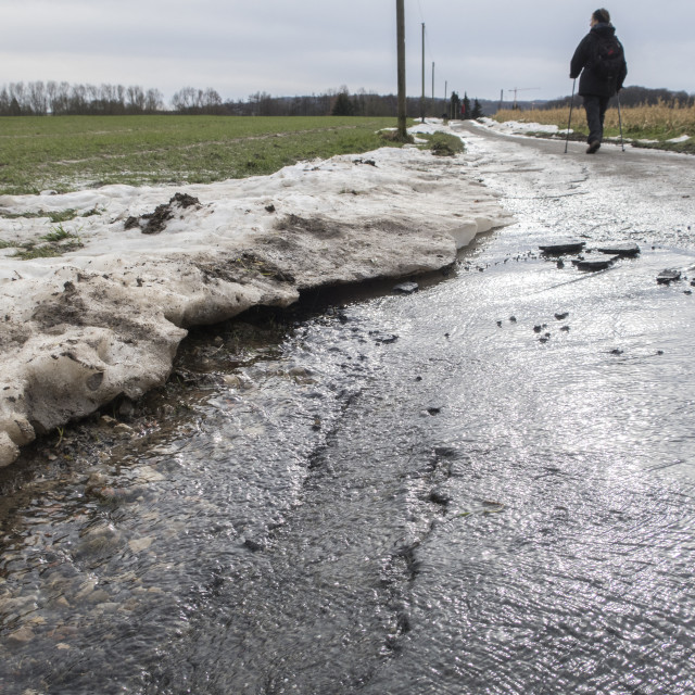 "flooded, frost damaged road" stock image