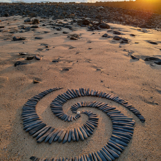 "A pulsating spiral of stones in the sunset" stock image