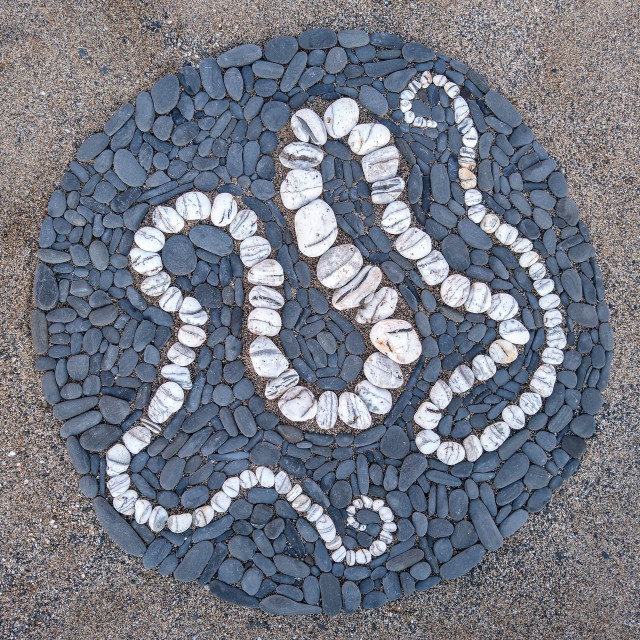 "White stone serpent in a dark pebble circle" stock image