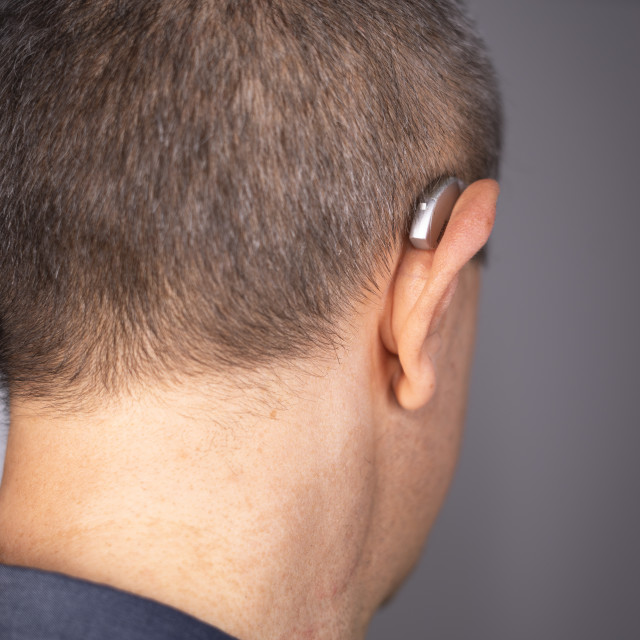 "Hearing aid ear of man" stock image