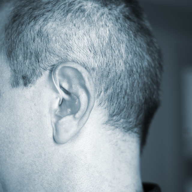 "Hearing aid ear of man" stock image