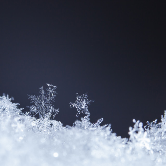"Large glittering snowflake on the snow background" stock image