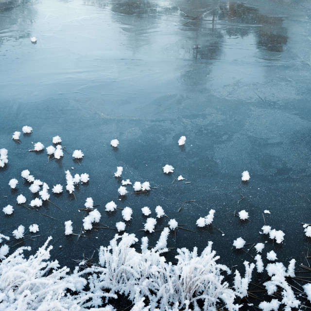 "Snow flakes on frozen lake" stock image