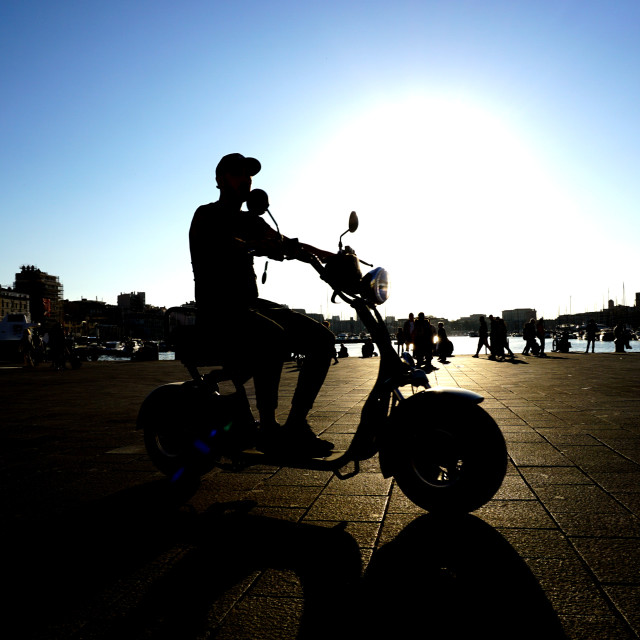 "silhouette of a man riding a scooter" by Amit Mendelsohn - $49.60 "silhouette of a man riding a scooter" stock image