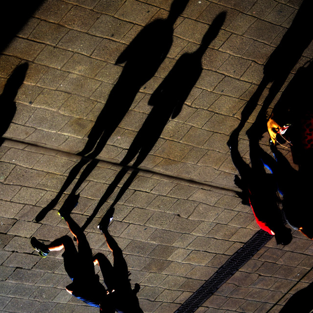 "Runners and their shadows" by Amit Mendelsohn - £50.00 "Runners and their shadows" stock image