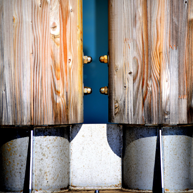 "Wooden poles over a metal base" by Amit Mendelsohn - £50.00 "Wooden poles over a metal base" stock image