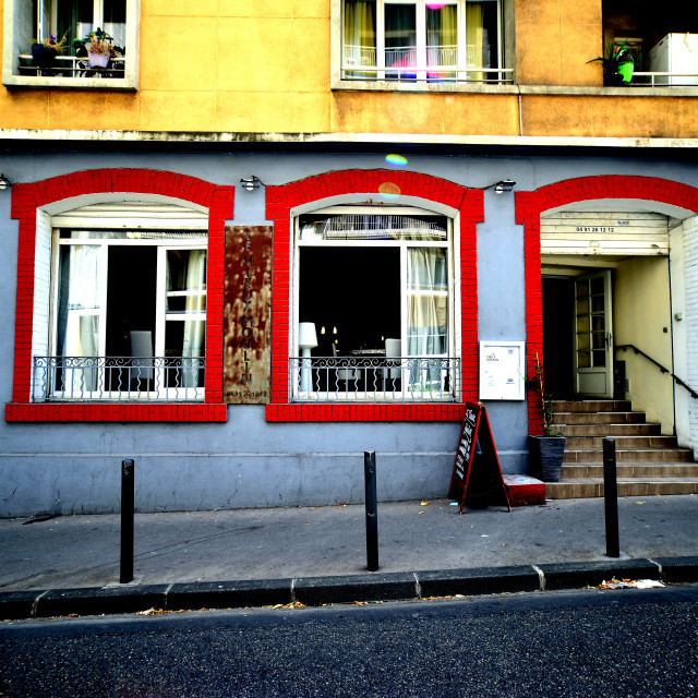 "A restaurant with windows and doors framed in red" by Amit Mendelsohn - £50.00 "A restaurant with windows and doors framed in red" stock image
