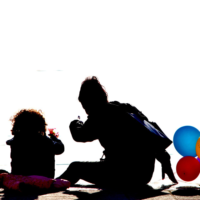 "Mum daughter and baloons" by Amit Mendelsohn - £50.00 "Mum daughter and baloons" stock image