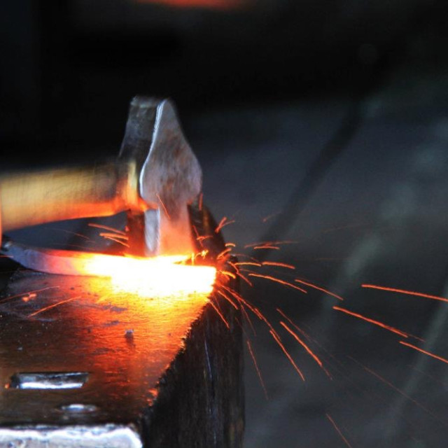 "Blacksmith Hammering Iron" stock image