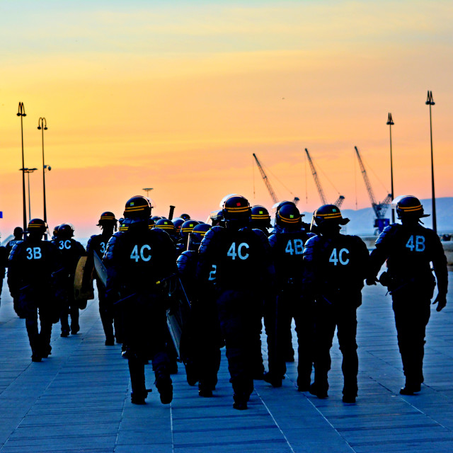 "Policemen walking toward the sunset" by Amit Mendelsohn - £50.00 "Policemen walking toward the sunset" stock image