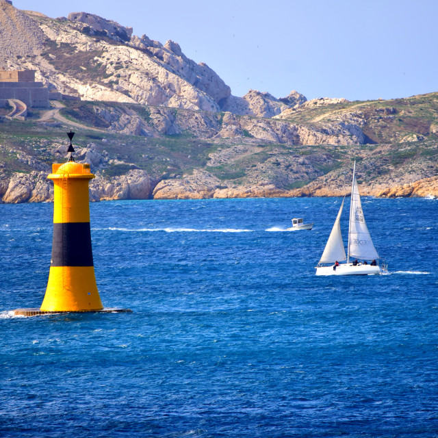 "white sail, and a yellow light tower" stock image