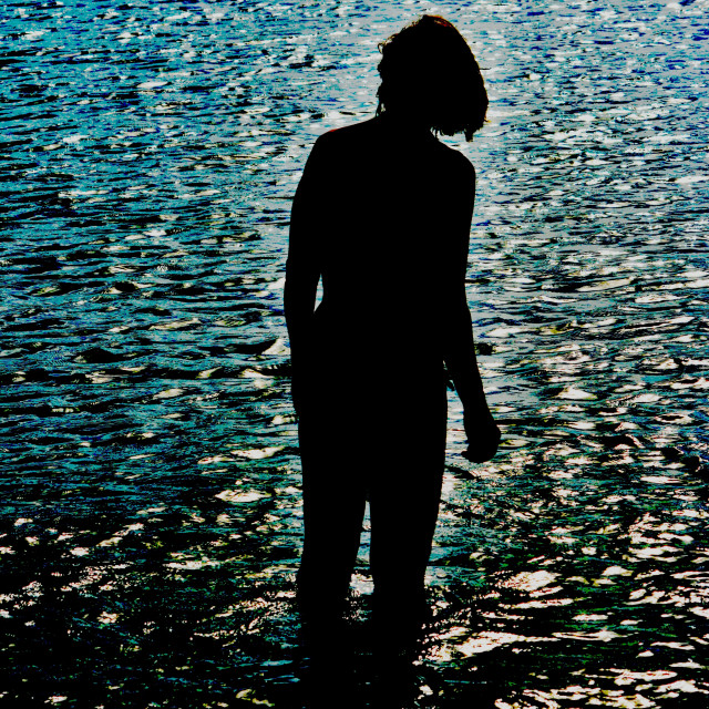 "A silhouette of a woman in the water" by Amit Mendelsohn - £50.00 "A silhouette of a woman in the water" stock image