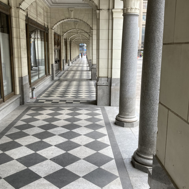 "A Stone Archway and Tile Sidewalk with Columns" stock image