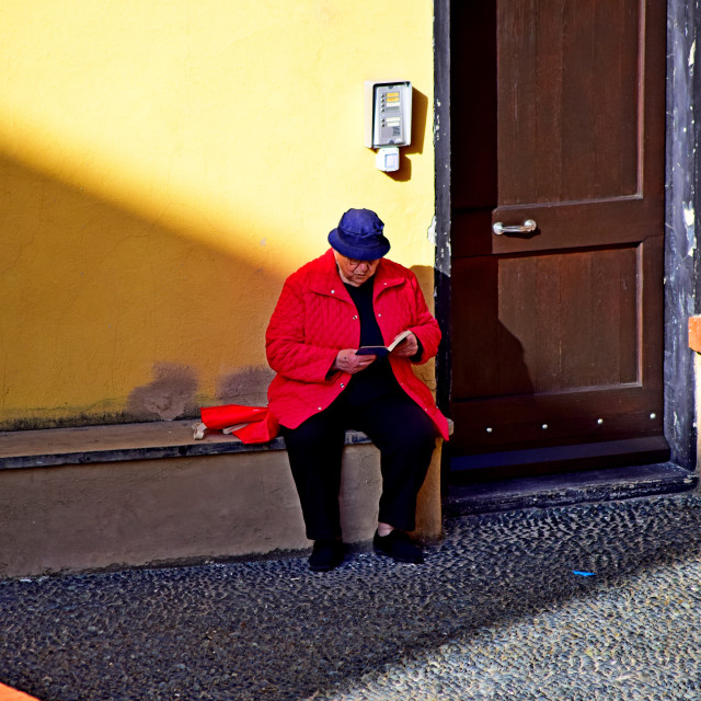 "A man reading in the street" by Amit Mendelsohn - £50.00 "A man reading in the street" stock image