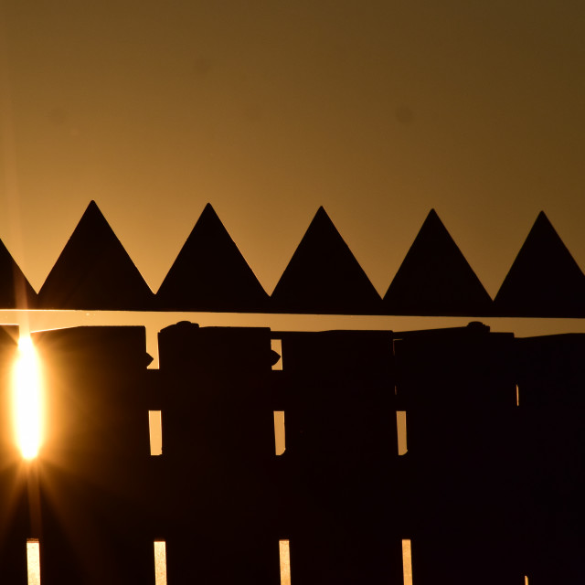 "Sunset through the fence" stock image