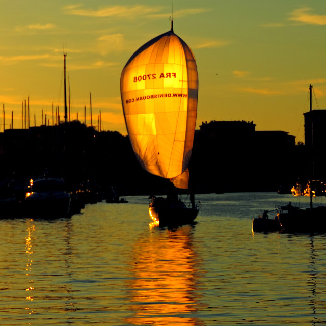 "A boat sailing with the sun" stock image