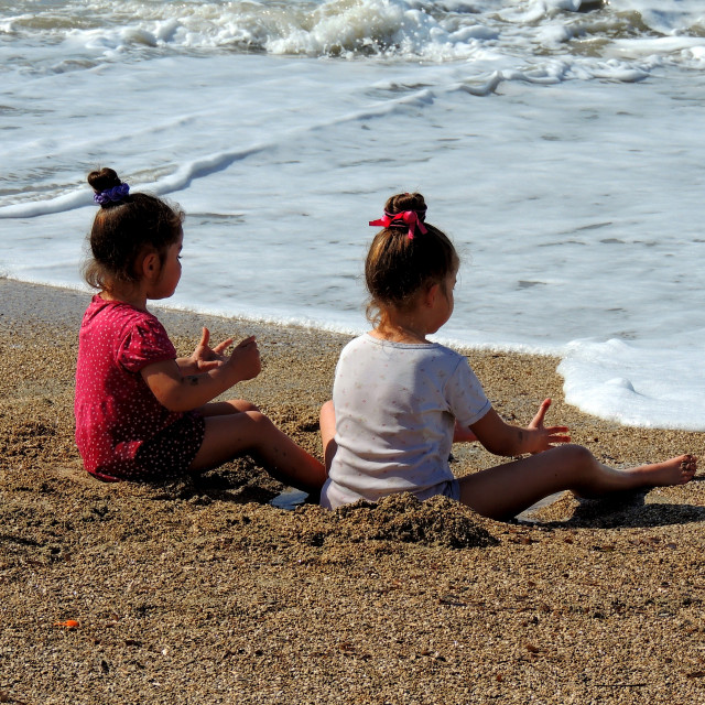 "Girls playing in the sand" by Amit Mendelsohn - £50.00 "Girls playing in the sand" stock image