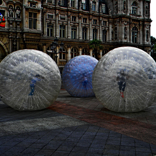 "Kids playing inside these balls" by Amit Mendelsohn - £50.00 "Kids playing inside these balls" stock image