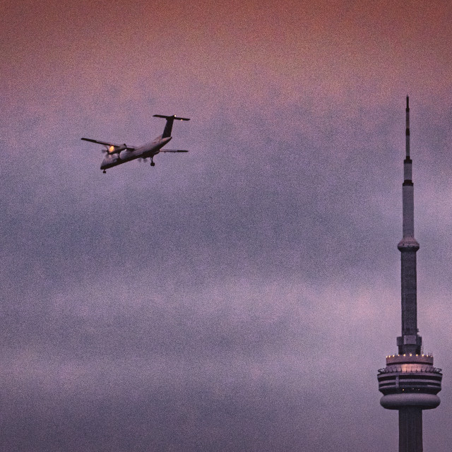 "Plane passing CN Tower" stock image